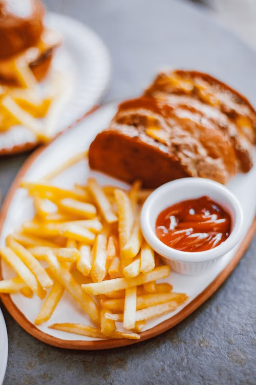 french fries on a plate with ketchup